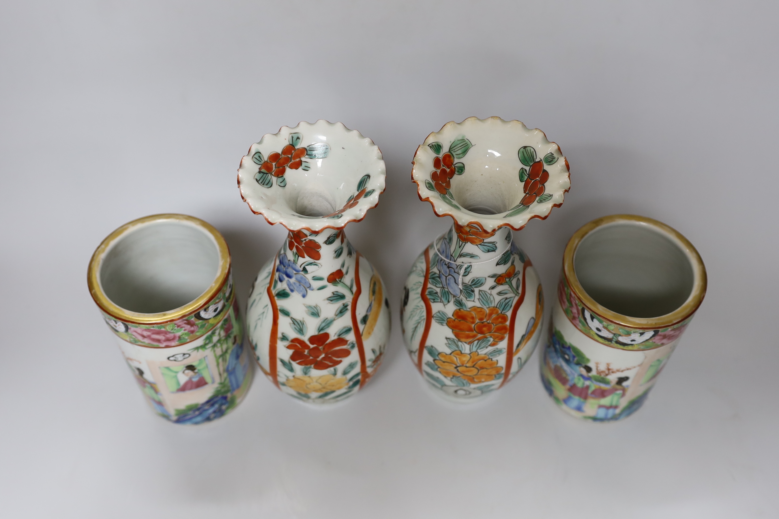 A pair of 19th century Cantonese famille rose porcelain brushpots, decorated with figural scenes, together with a further pair of Japanese export vases (4)